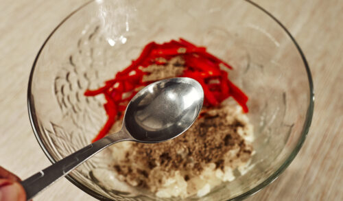 Adding vinegar to the onion and pepper mixture
