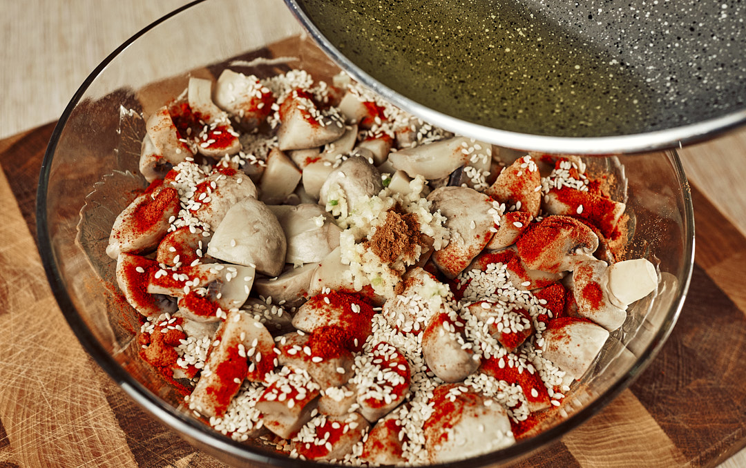 Hot oil being poured over garlic mixture for salad