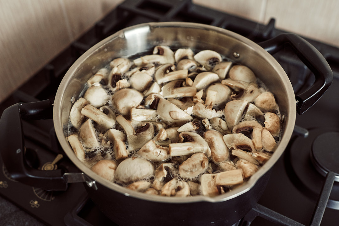 Chopped mushrooms in a pot of salted boiling water