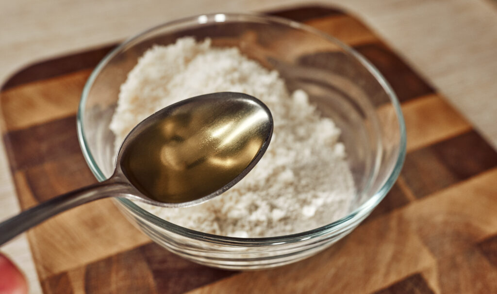 Adding olive oil and herbs to the coating mixture