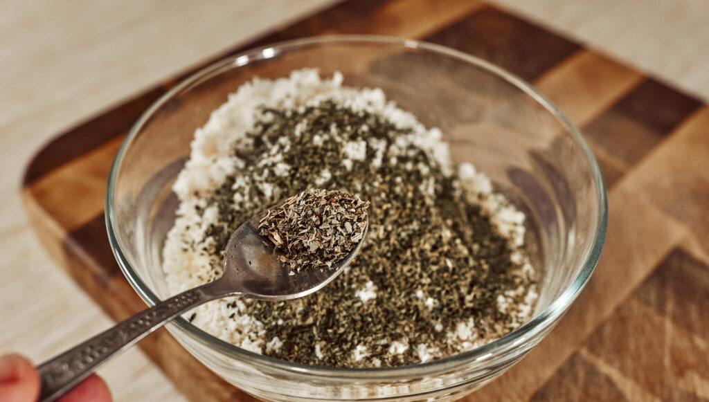 Adding black pepper over Parmesan breadcrumbs