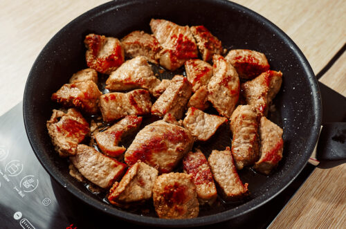 Browned pork pieces ready for braising