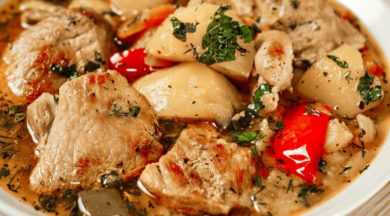 Braised potatoes with pork served in a skillet