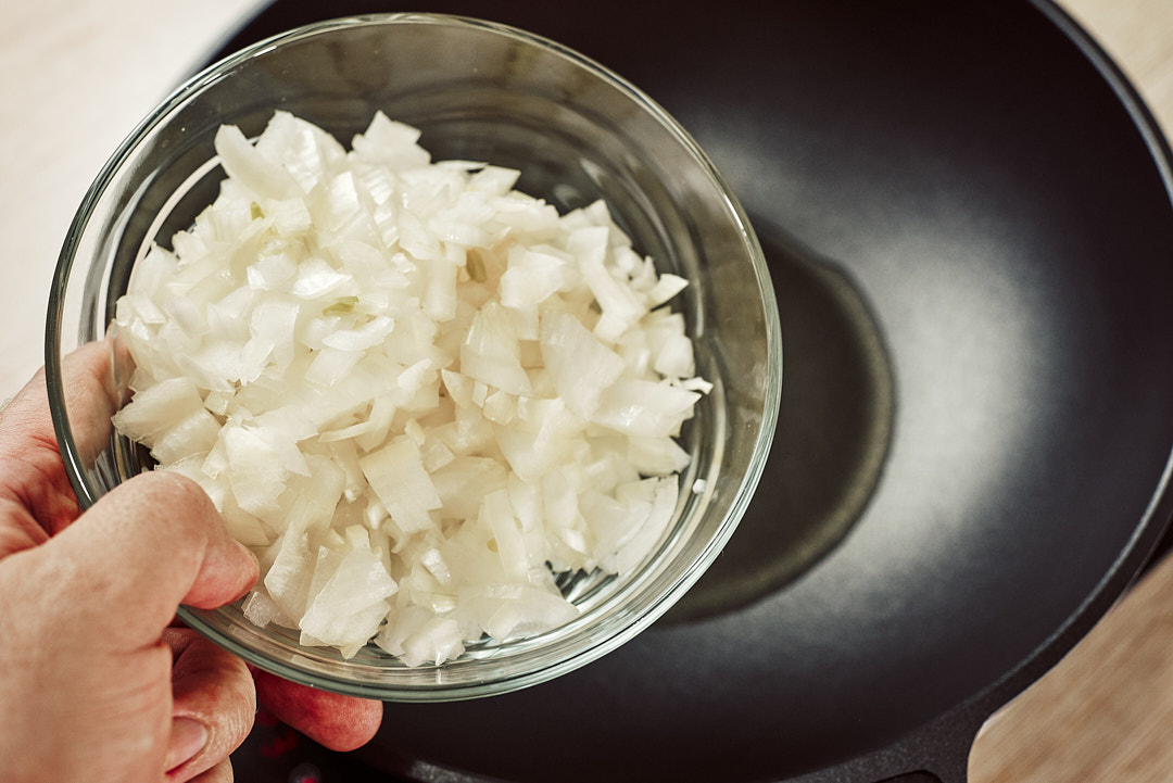 Sautéing chopped onion until golden