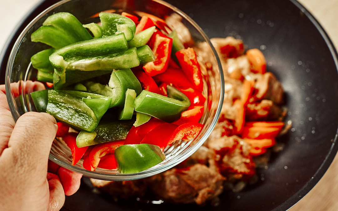 Bell pepper added to onion and carrot