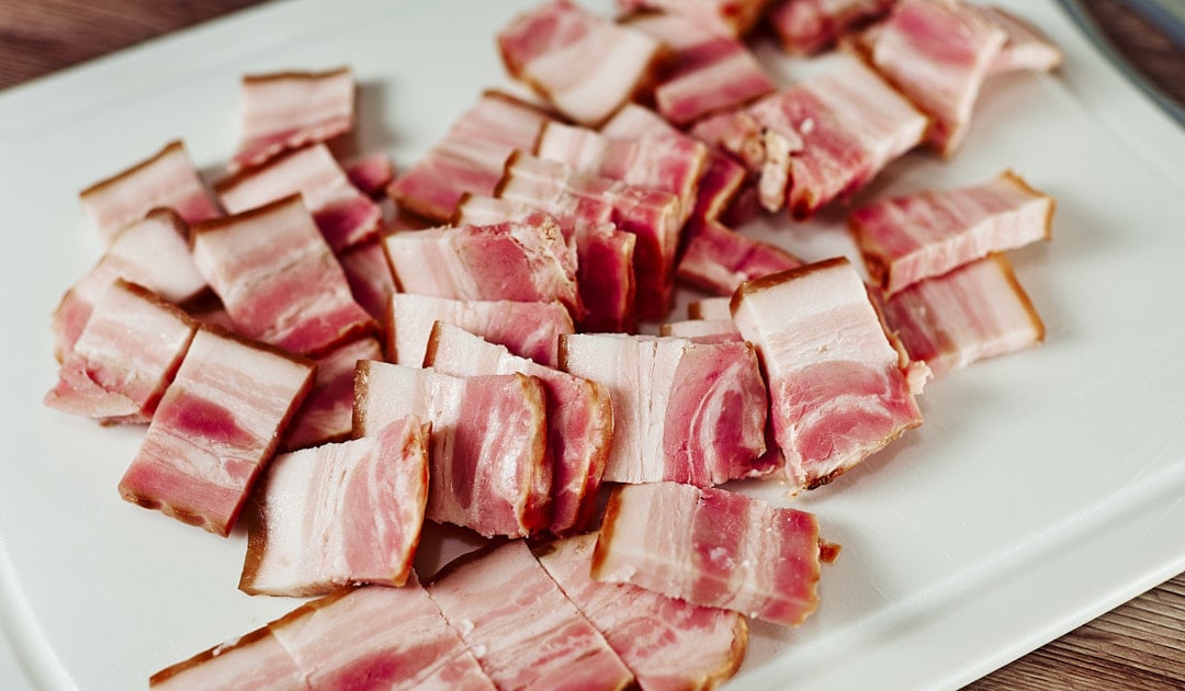 Bacon pieces in skillet for creamy Dijon chicken