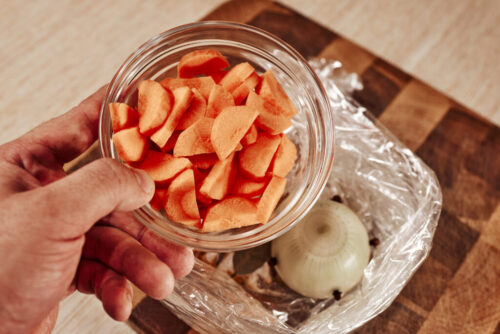 adding chopped carrots to baking bag for rice mixture