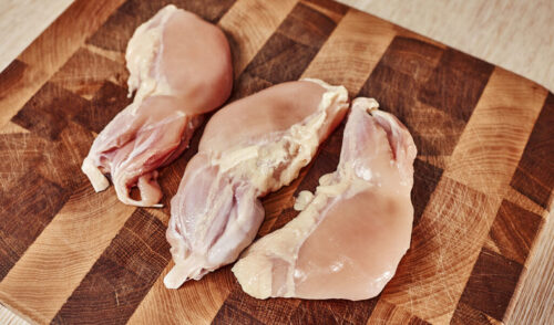 Seasoning chicken thighs with salt and black pepper
