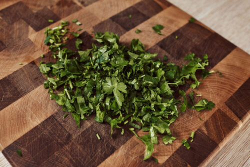 Adding fresh parsley to the celery root salad bowl