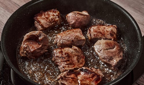 Searing beef for beef bourguignon in bacon fat