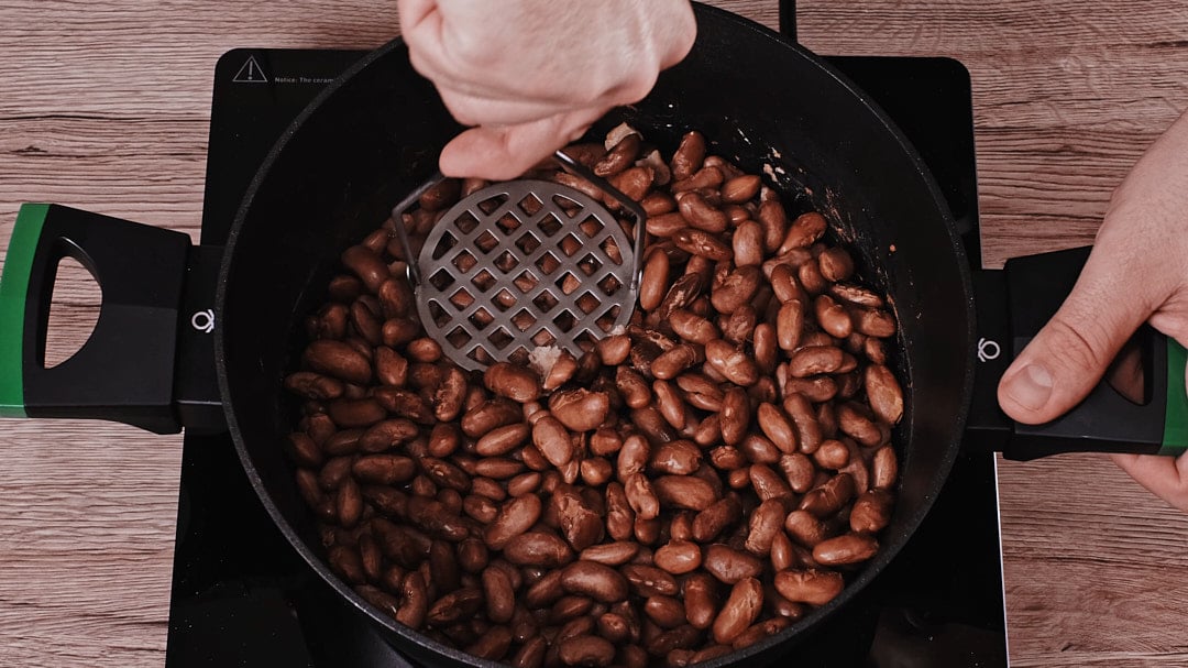 Mashing some of the beans for creamy texture