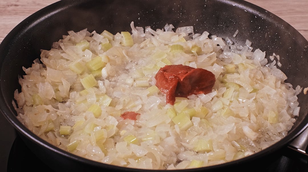 Tomato paste caramelizing with aromatics