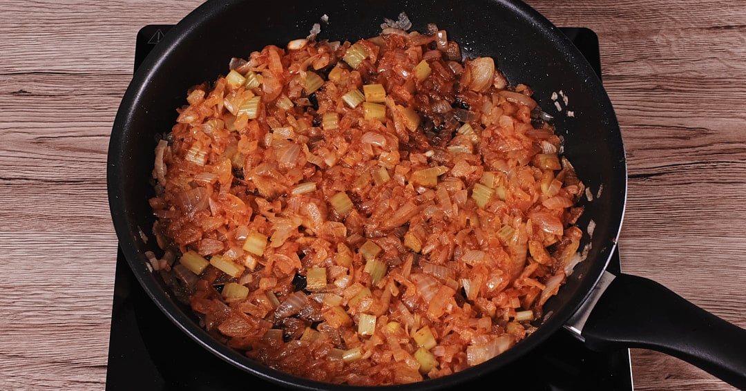 Tomato paste added to sautéed aromatics