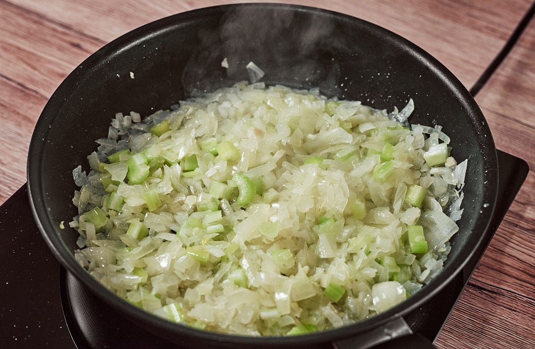 Chopped onions and celery in skillet with oil