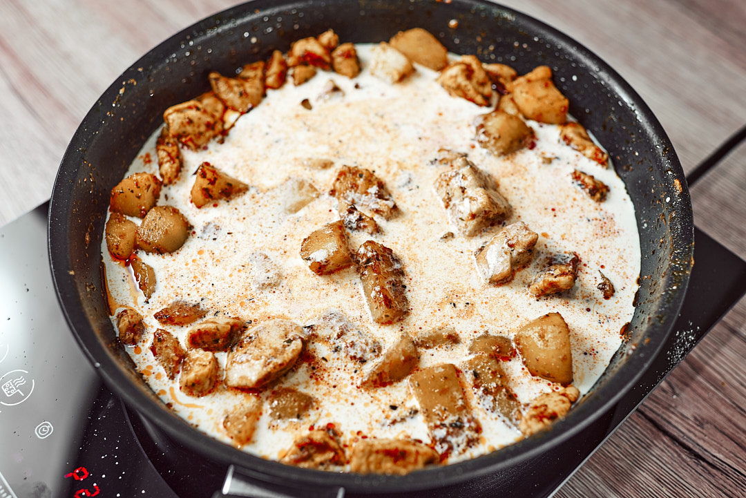 Chicken simmering in paprika cream sauce
