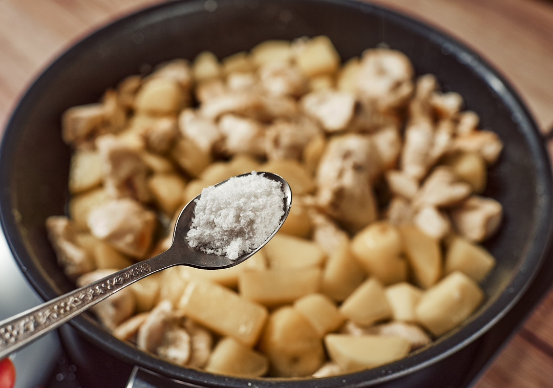 Adding salt to season the chicken