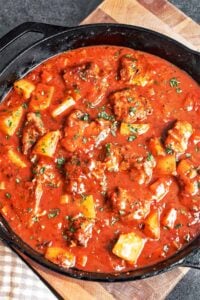 Cozy pork stew with potatoes, tender pork, carrots, and herbs in a rich tomato sauce
