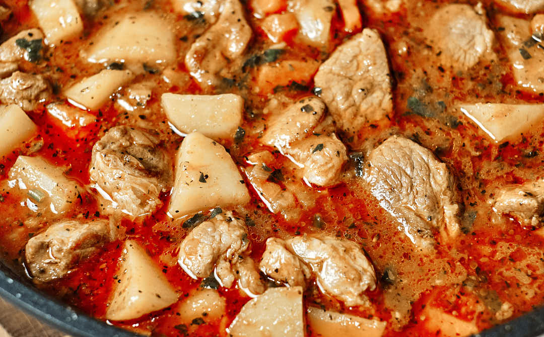 Finished pork stew garnished with parsley