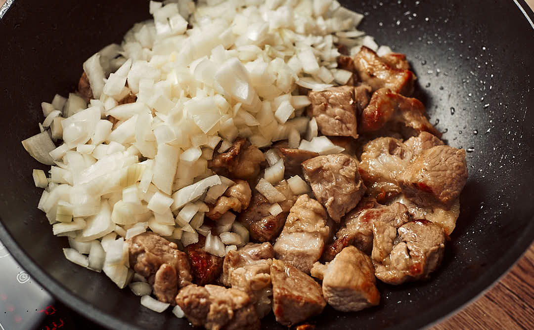 Golden sautéed onions in pot