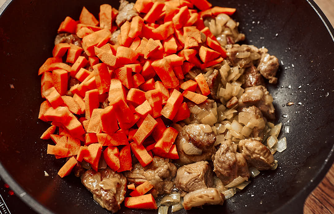 Carrots added to sautéed onions