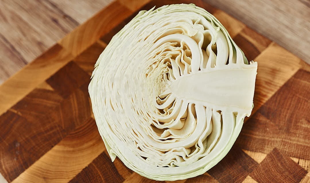 Slicing cabbage into thin strips with a knife