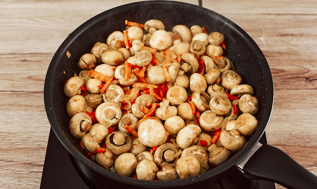 Mushrooms cooking in a skillet