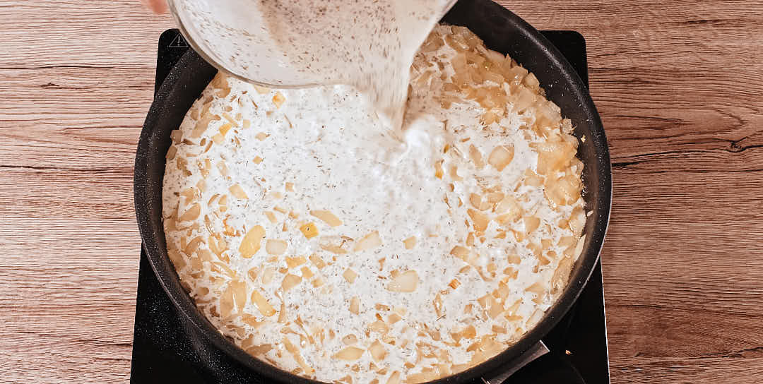 Mixing dill garlic cream sauce for schnitzel