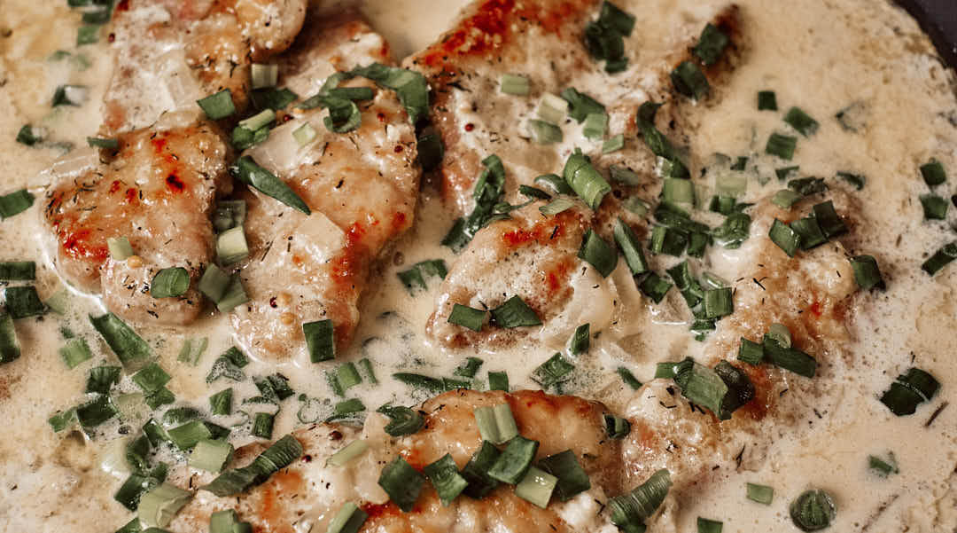 Pork schnitzel served with creamy dill gravy and parsley