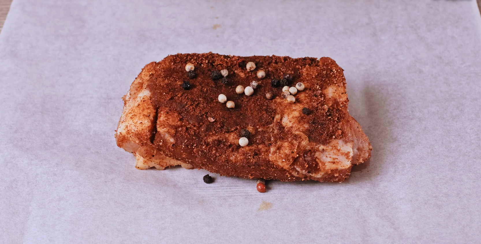 Scatter peppercorns on top pork belly