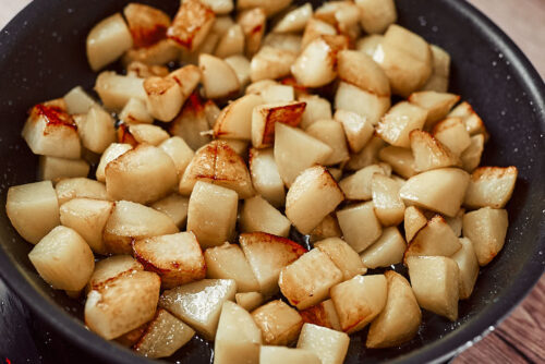 Sautéing potatoes in olive oil for one-pot vegan stew