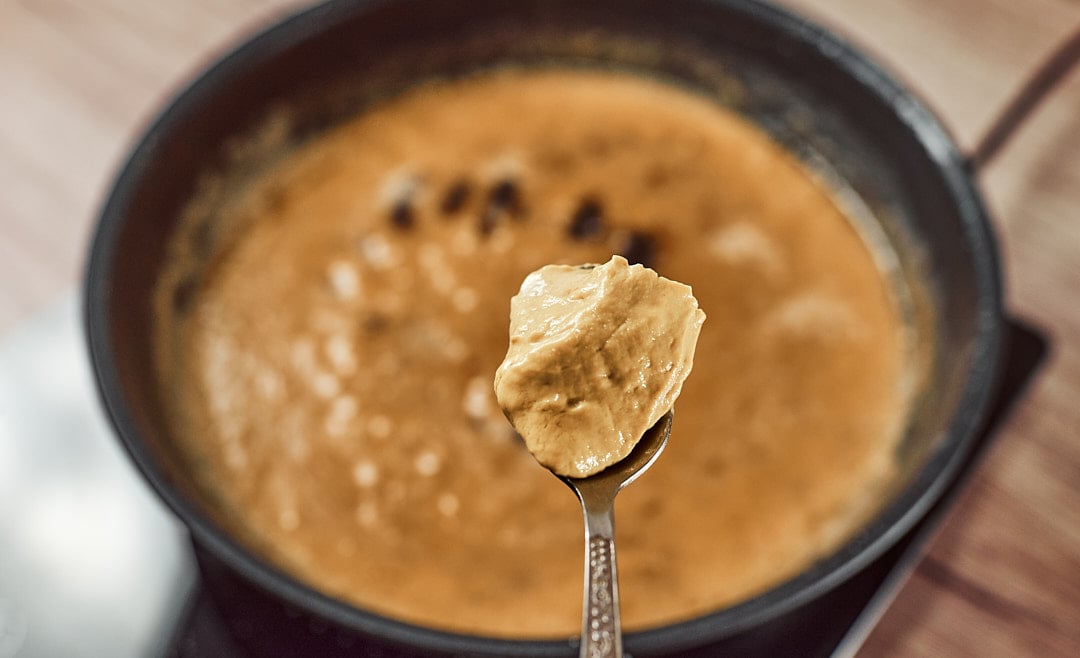 Adding mustard for meatball sauce