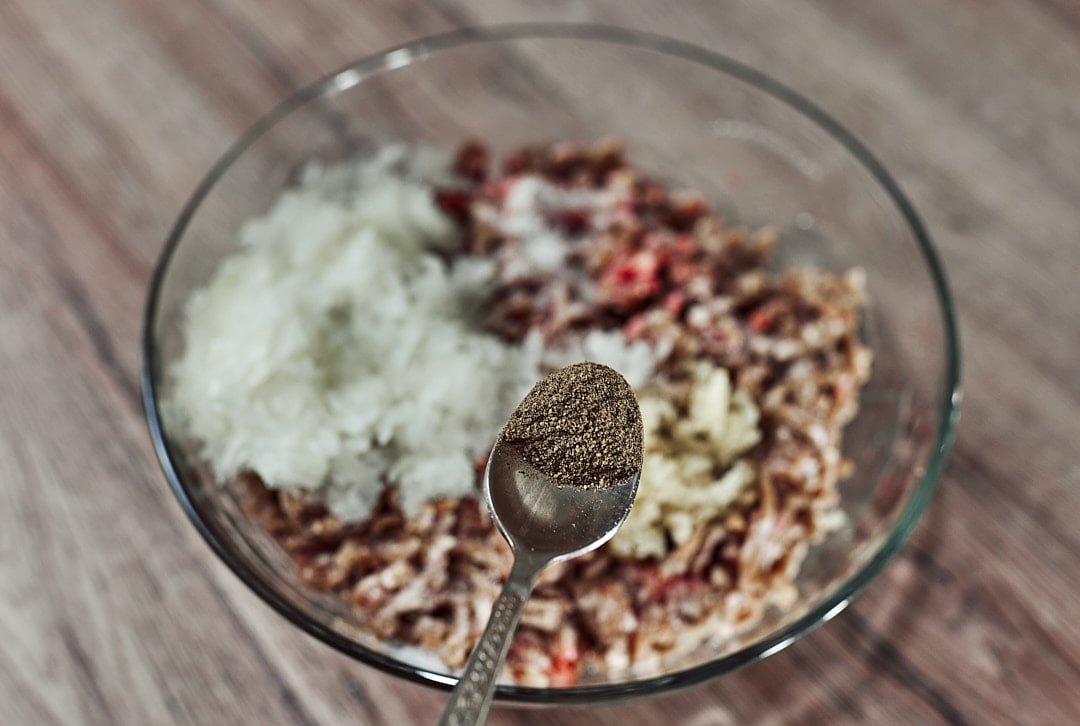 Adding black pepper for meatballs
