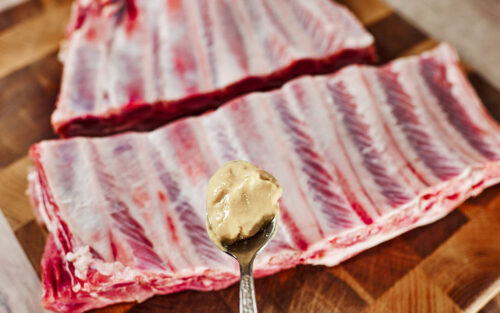 Mustard binder on ribs before seasoning