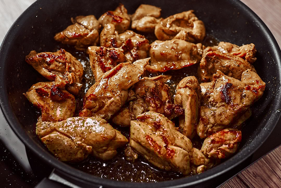 Browning chicken thighs in skillet