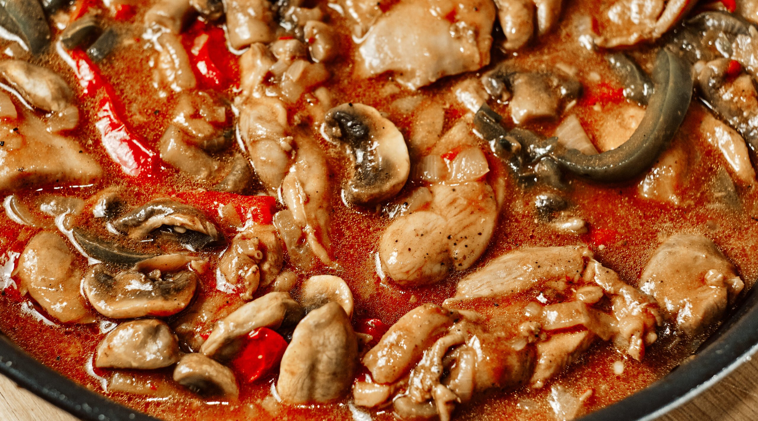 Finished goulash chicken in tomato sauce with bell pepper in pan