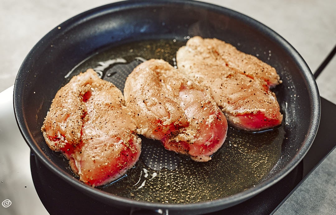 Searing chicken breasts in skillet