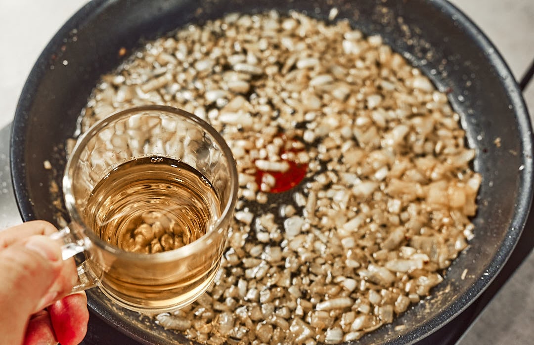 Adding white wine and onion for sauce
