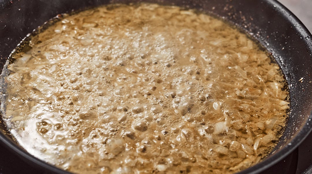 Adding white wine and onion for sauce