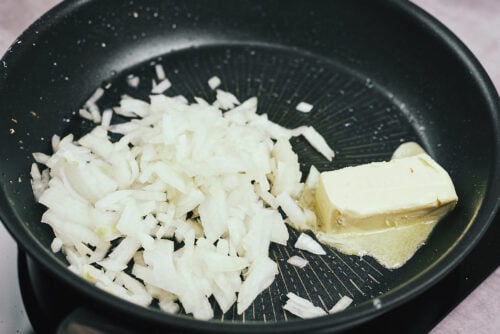 Onions sautéing in a skillet with butter