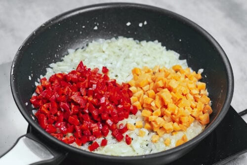 Carrot and bell pepper cooking in the skillet