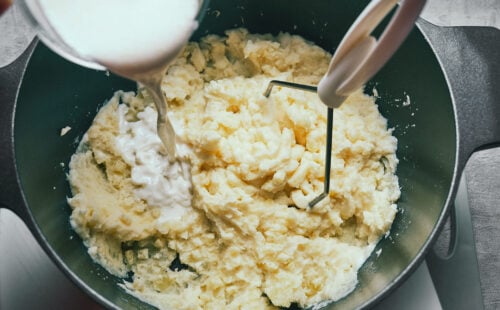 Cooking liquid being added to mashed potatoes