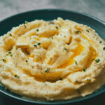 Finished mashed potatoes in pot, creamy and smooth