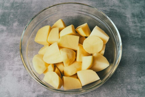 Bowl of diced potatoes prepared for boiling