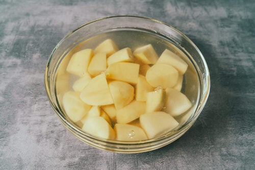 Diced potatoes soaking in fresh water before cooking