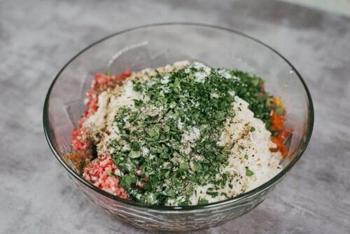 Rice, parsley, and vegetables added to the meat mixture for stuffed cabbage rolls.