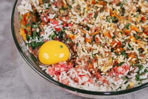 Egg added to the meat, rice, and vegetable mixture before mixing.