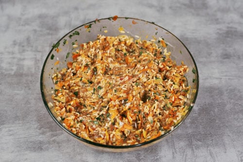 Fully mixed cabbage roll filling with meat, rice, parsley, and vegetables.