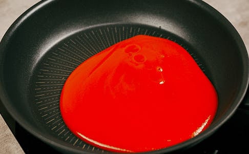 Tomato purée added to a saucepan to make cabbage roll sauce.