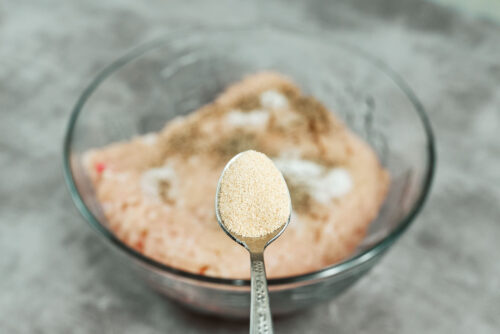 Garlic powder added to ground chicken for meatballs