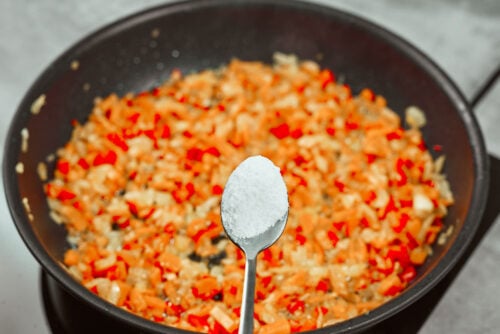Salt added to vegetable mixture for chicken meatballs sauce